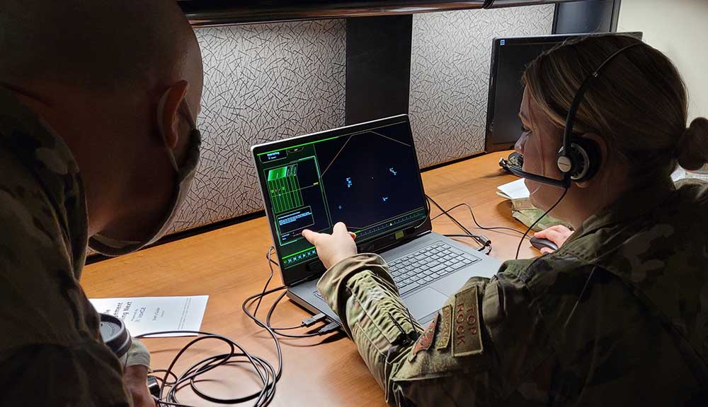 Air National Guardsmen train using an AI/ML enabled serious game simulation system.